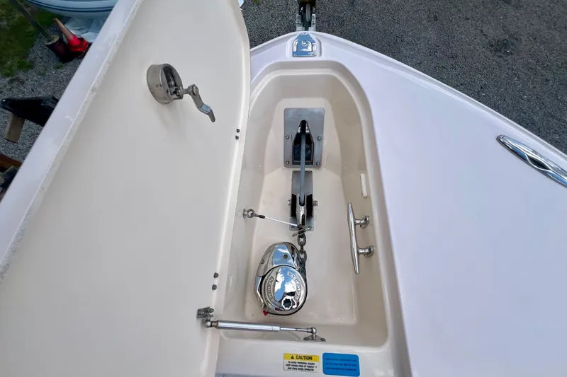 Slide: The Image of Anchor compartment of 2013 Grady-White Canyon 336 boat, featuring stainless steel hardware. - 46