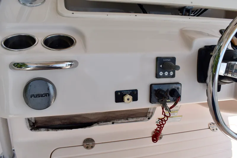 Slide: The Image of Control panel of a 2013 Grady-White Canyon 336 boat with steering wheel and switches. - 74