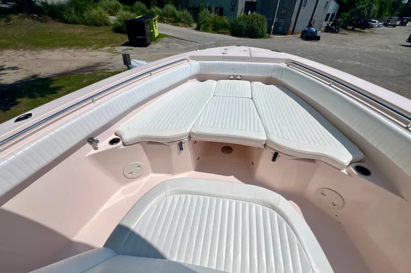 Slide: The Image of 2013 Grady-White Canyon 336 boat interior with white cushioned seating. - 27