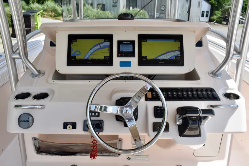 Slide: The Image of 2013 Grady-White Canyon 336 boat dashboard with dual navigation screens and steering wheel. - 70