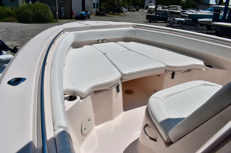 Slide: The Image of 2013 Grady-White Canyon 336 boat interior with cushioned seating and storage. - 60