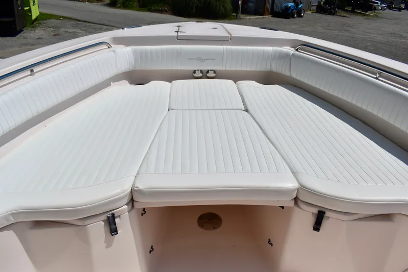 Slide: The Image of 2013 Grady-White Canyon 336 boat with spacious white cushioned seating area. - 61