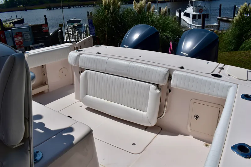Slide: The Image of 2013 Grady-White Canyon 336 boat interior with seating and twin outboard engines. - 52