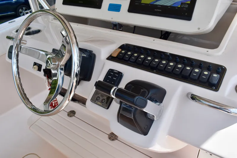 Slide: The Image of Control panel of a 2013 Grady-White Canyon 336 boat with steering wheel and navigation equipment. - 75