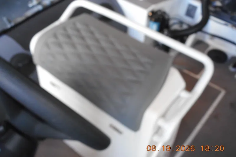 Slide: The Image of Blurry interior view of a 2025 Highfield Patrol 540 boat seat and steering area. - 11