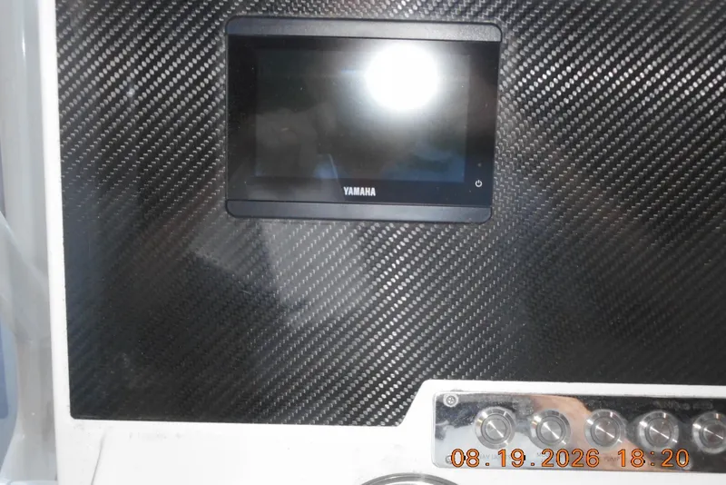 Slide: The Image of Carbon fiber dashboard with Yamaha display on 2025 Highfield Patrol 540 boat. - 9