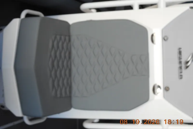 Slide: The Image of Cushioned seat of 2025 Highfield Patrol 540 boat, featuring textured gray upholstery. - 7