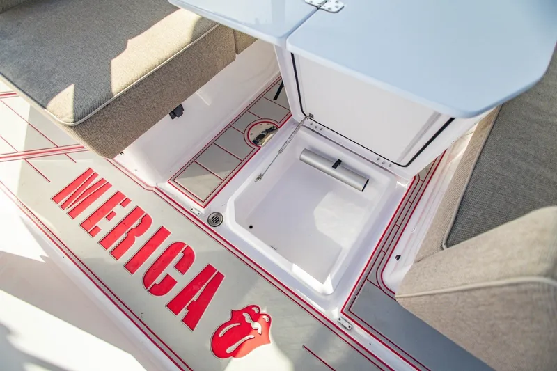 Slide: The Image of 2025 Axopar 37 Sun-Top boat interior with seating and storage compartment. - 30