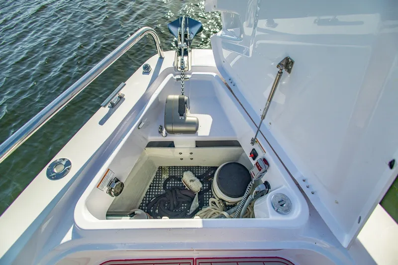 Slide: The Image of Anchor storage compartment on 2025 Axopar 37 Sun-Top boat, featuring ropes and equipment. - 39