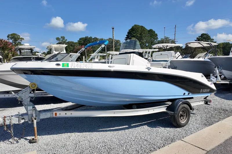 The Image of 2024 Yamaha Boats 195 FSH Sport on trailer, displayed outdoors under clear sky. - 1