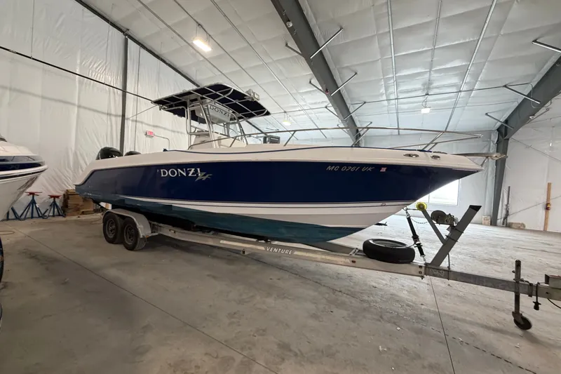 The Image of 2007 Donzi 29 ZF Cuddy boat on trailer in indoor storage facility. - 1