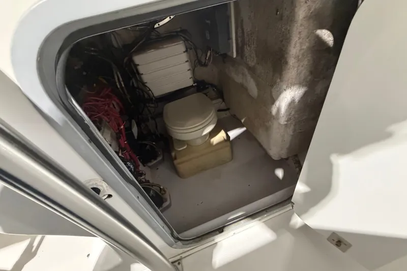 Slide: The Image of 2007 Donzi 29 ZF Cuddy interior showing compact marine toilet and wiring. - 15