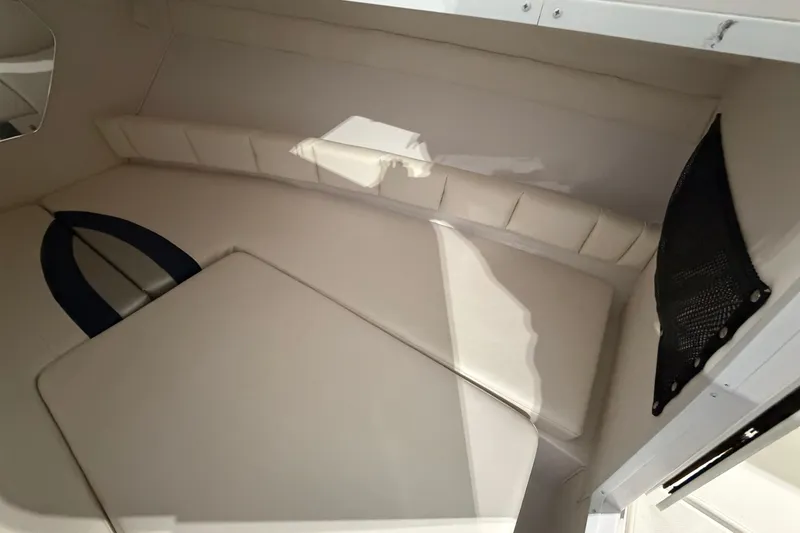 Slide: The Image of 2007 Donzi 29 ZF Cuddy cabin interior with cushioned seating and storage net. - 19