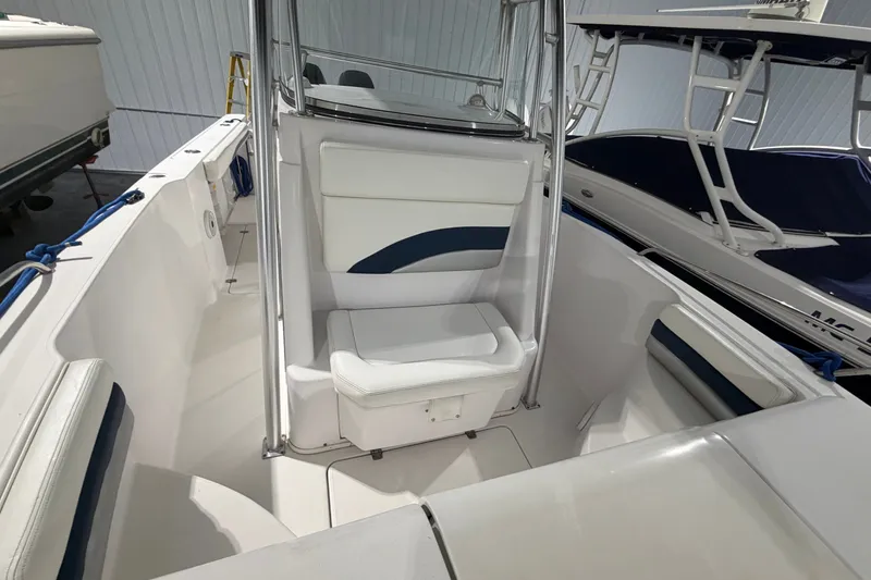 Slide: The Image of 2007 Donzi 29 ZF Cuddy boat interior with white seating and blue accents. - 16