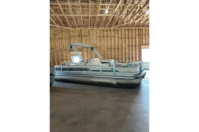 Slide: The Image of 1995 Premier 210 Cast-A-Way pontoon boat in a wooden garage. - 4