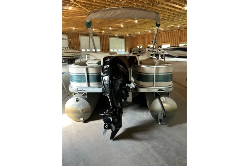 Slide: The Image of 1995 Premier 210 Cast-A-Way pontoon boat with Mercury outboard motor in storage. - 3