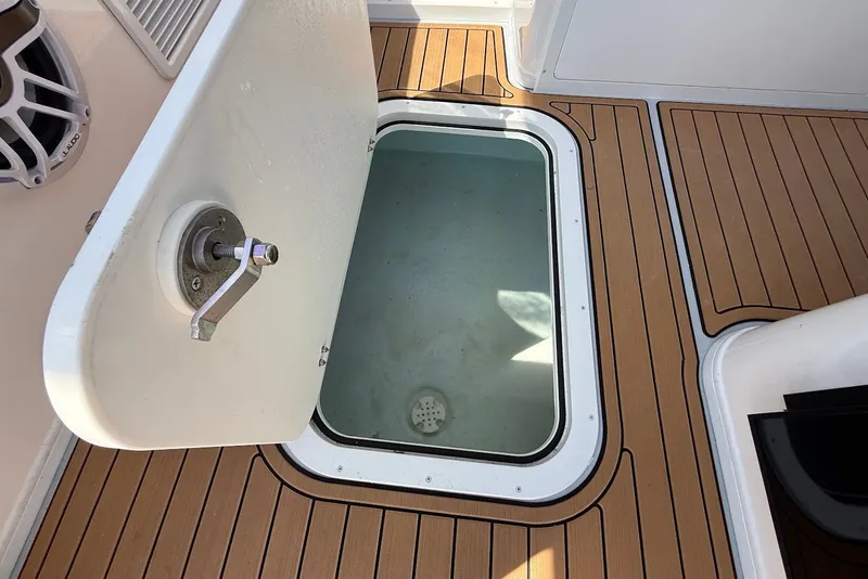 Slide: The Image of Open hatch on 2026 Steiger Craft 28 Annapolis boat with teak flooring. - 28