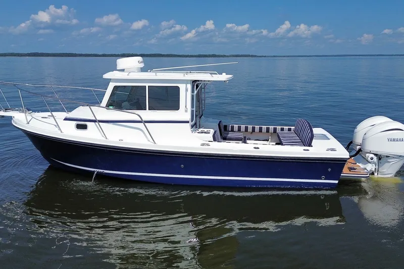 The Image of 2026 Steiger Craft 28 Annapolis boat on calm water under blue sky. - 2