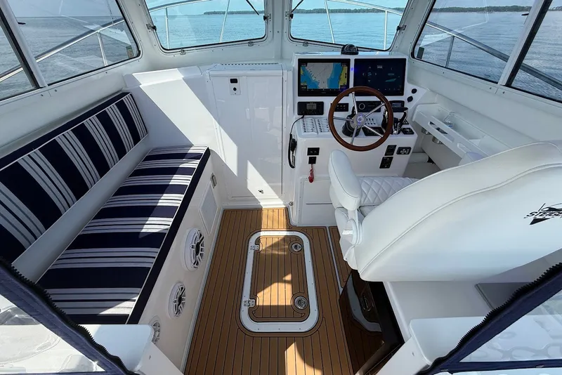 Slide: The Image of Interior of 2026 Steiger Craft 28 Annapolis boat with striped seating and modern helm. - 22