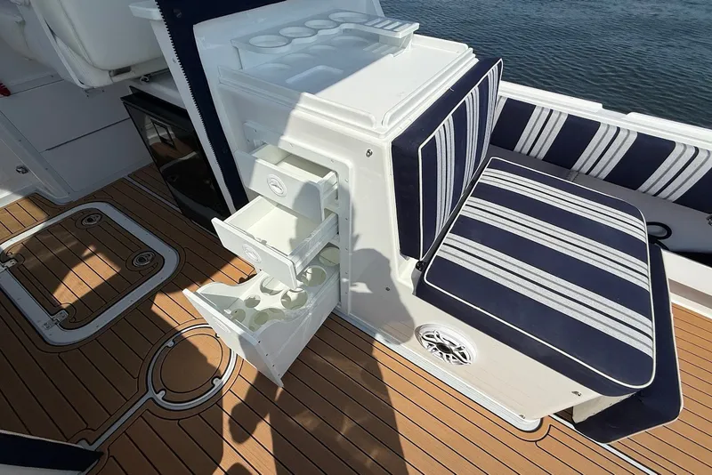 Slide: The Image of Interior of 2026 Steiger Craft 28 Annapolis boat with striped seating and storage drawers. - 20