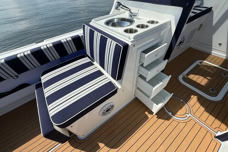 Slide: The Image of 2026 Steiger Craft 28 Annapolis boat interior with striped seating and open storage drawers. - 21