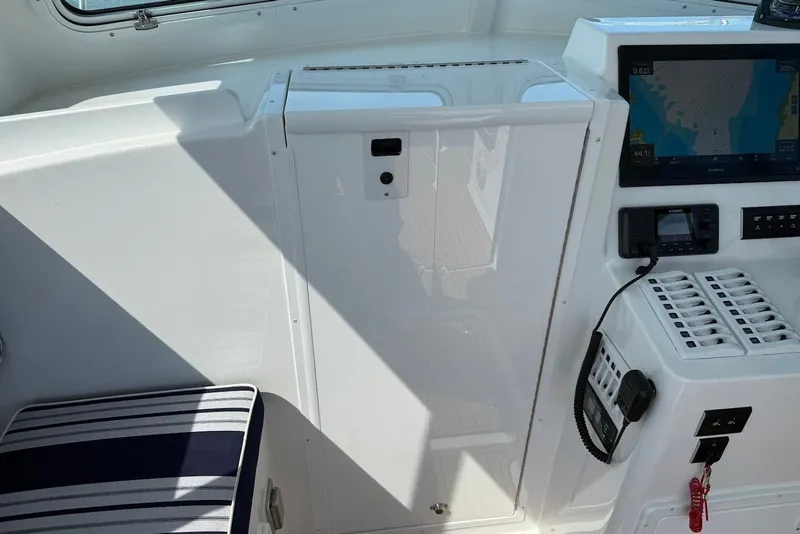 Slide: The Image of Interior of 2026 Steiger Craft 28 Annapolis boat with navigation equipment and seating. - 33