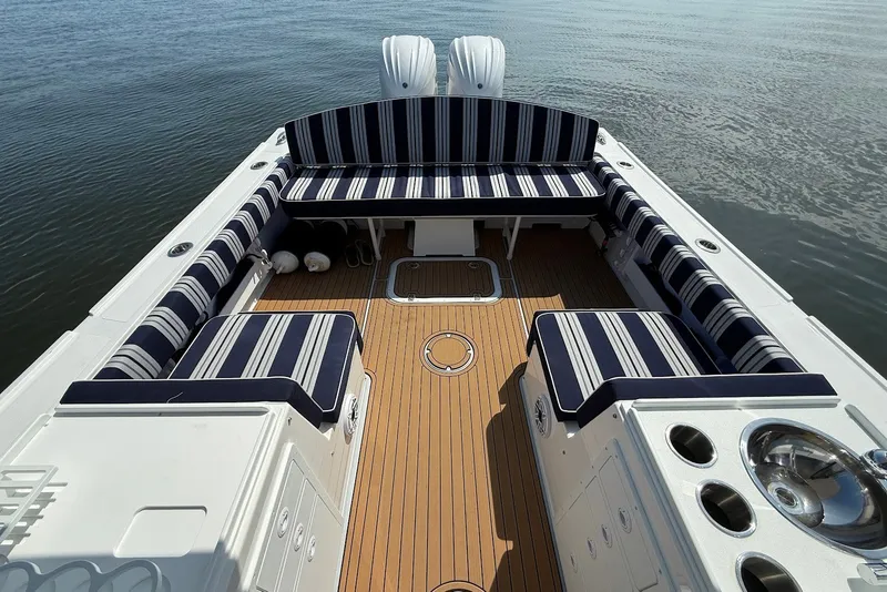 Slide: The Image of 2026 Steiger Craft 28 Annapolis boat interior with striped seating and wooden deck. - 19