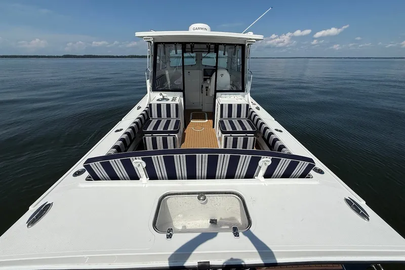 Slide: The Image of 2026 Steiger Craft 28 Annapolis boat with striped seating on calm water. - 14
