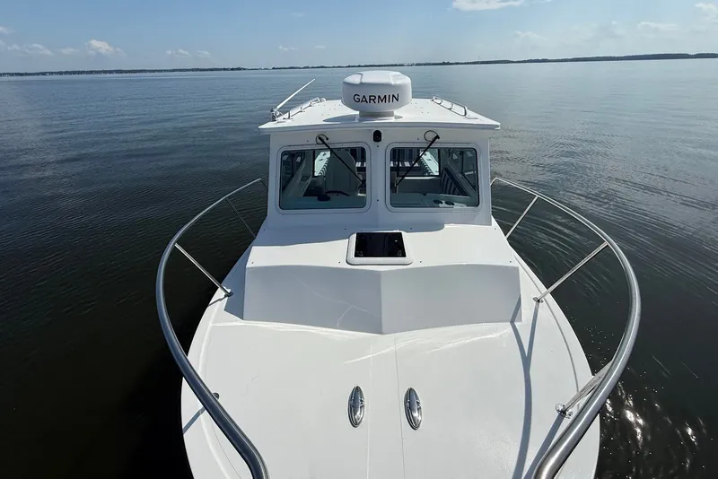 Slide: The Image of 2026 Steiger Craft 28 Annapolis boat on calm water, featuring Garmin equipment. - 38