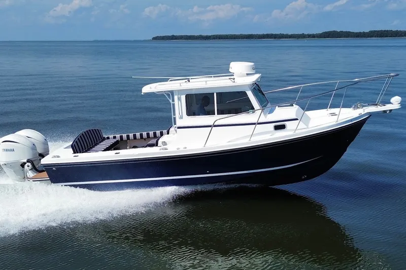 Slide: The Image of 2026 Steiger Craft 28 Annapolis boat cruising on calm waters. - 11
