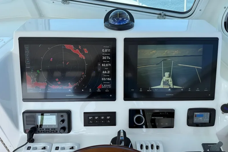 Slide: The Image of Steiger Craft 28 Annapolis 2026 helm with dual Garmin displays and navigation controls. - 32
