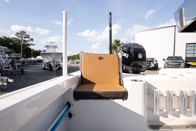 Slide: The Image of 2027 Sea Pro 230 Bay boat interior with tan seating and Suzuki outboard motor. - 16