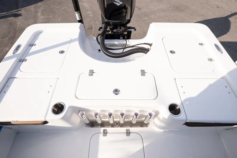 Slide: The Image of 2027 Sea Pro 230 Bay boat deck with storage compartments and motor. - 15