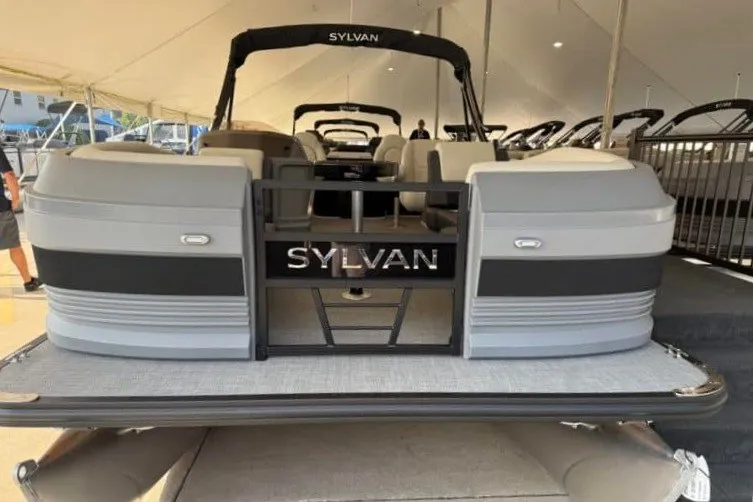 Slide: The Image of 2027 Sylvan R-20 PARTY FISH pontoon boat displayed at a boat show. - 2