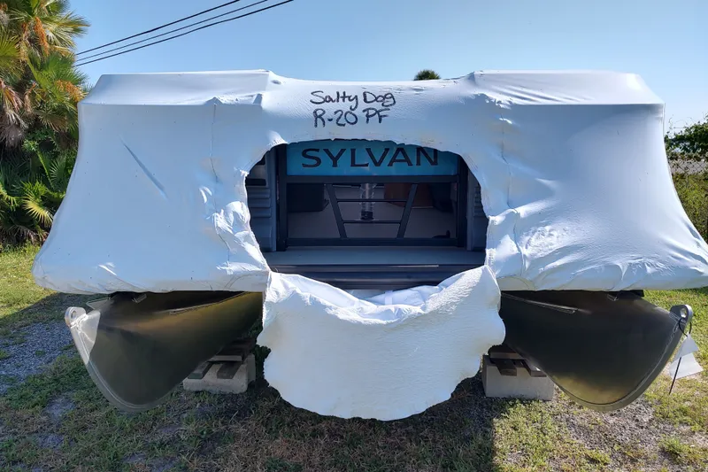 The Image of Covered 2027 Sylvan R-20 PARTY FISH boat with protective wrap, labeled "Salty Dog R-20 PF." - 0