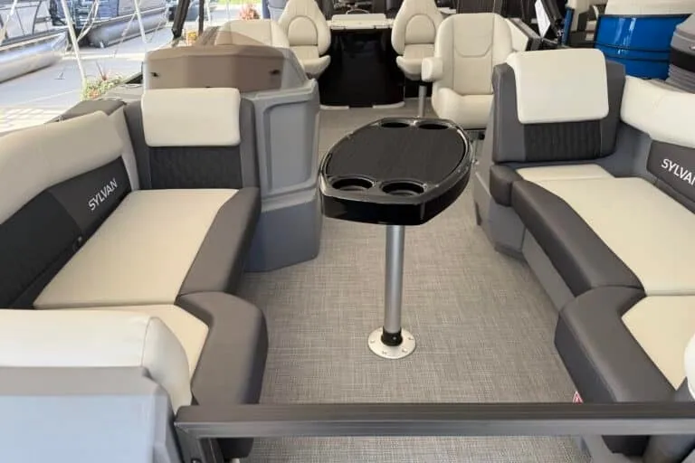 Slide: The Image of 2027 Sylvan R-20 PARTY FISH boat interior with plush seating and central table. - 4