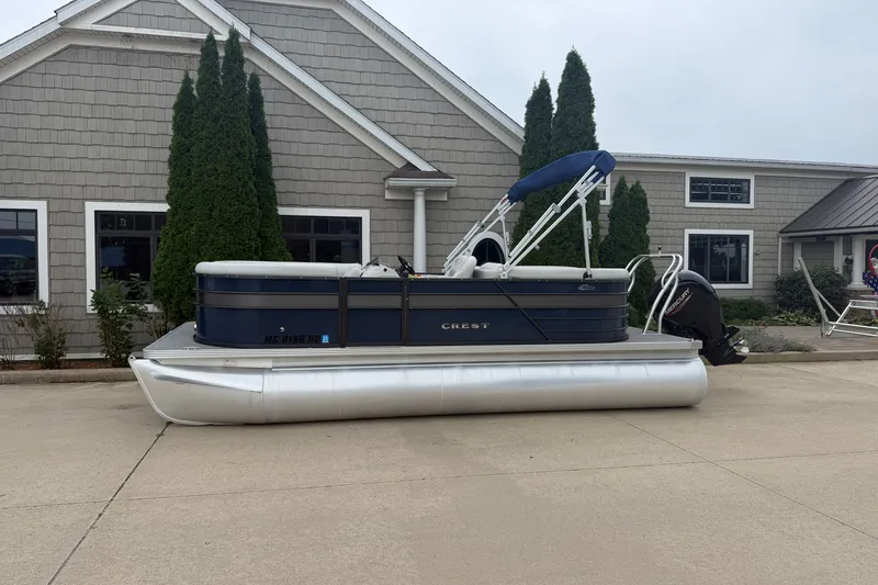 The Image of 2022 Crest Classic LX 200 SLC pontoon boat parked outside a building. - 1