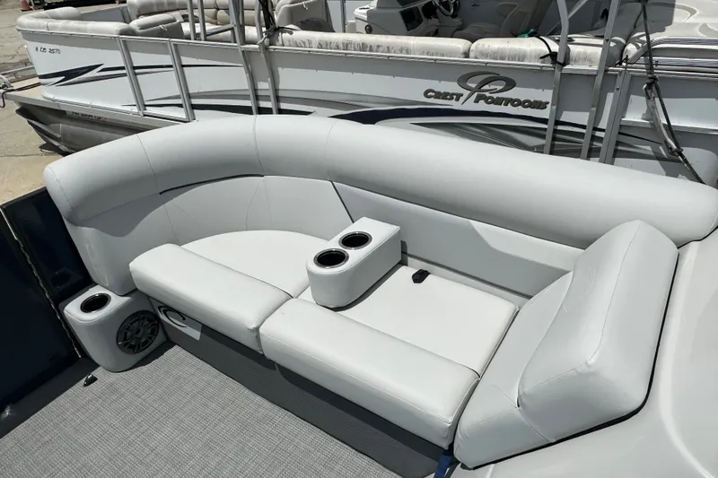 Slide: The Image of 2022 Crest Classic LX 200 SLC pontoon boat with plush seating and cup holders. - 15