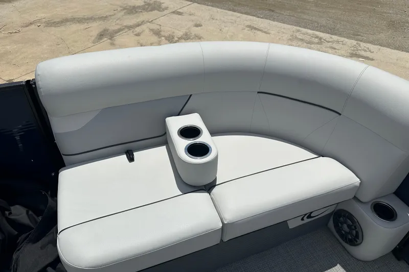 Slide: The Image of 2022 Crest Classic LX 200 SLC boat interior with white cushioned seating and cup holders. - 14