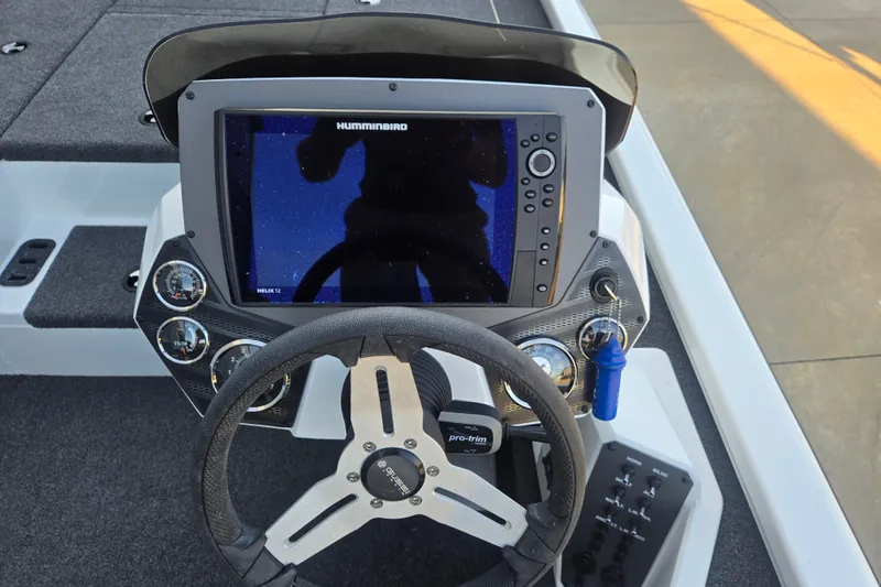 The Image of 2024 Vexus AVX1980C boat dashboard with Humminbird Helix 12 display and steering wheel. - 1
