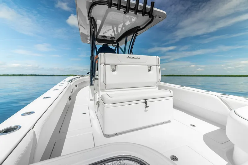 Slide: The Image of 2024 SeaHunter 28 Floridian boat on calm water under a clear blue sky. - 15