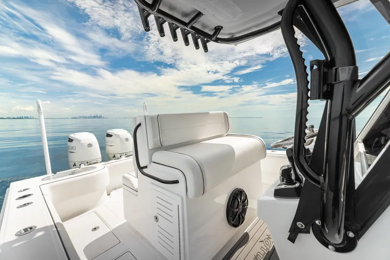 Slide: The Image of 2024 SeaHunter 28 Floridian boat interior with dual Suzuki engines, ocean view. - 11