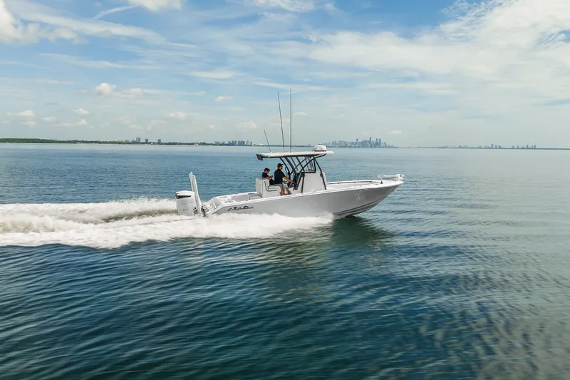 Slide: The Image of 2024 SeaHunter 28 Floridian cruising on open water under a clear sky. - 3
