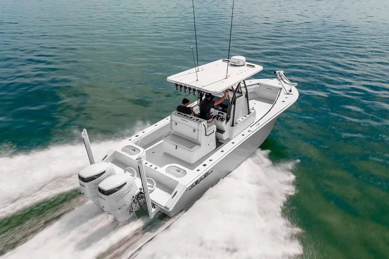 Slide: The Image of 2024 SeaHunter 28 Floridian boat cruising on clear blue water. - 9