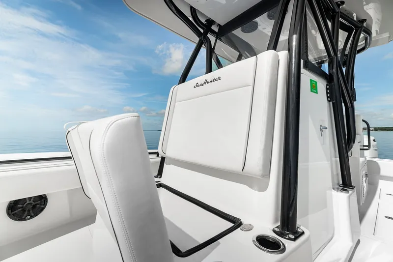 Slide: The Image of 2024 SeaHunter 28 Floridian boat interior with sleek white seating and ocean backdrop. - 22