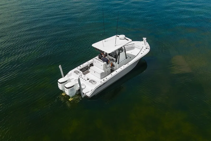 Slide: The Image of 2024 SeaHunter 28 Floridian boat on calm water, featuring dual engines and sleek design. - 8