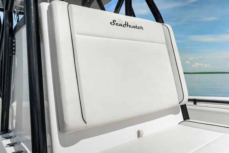 Slide: The Image of 2024 SeaHunter 28 Floridian boat seat with logo, against a serene water backdrop. - 21
