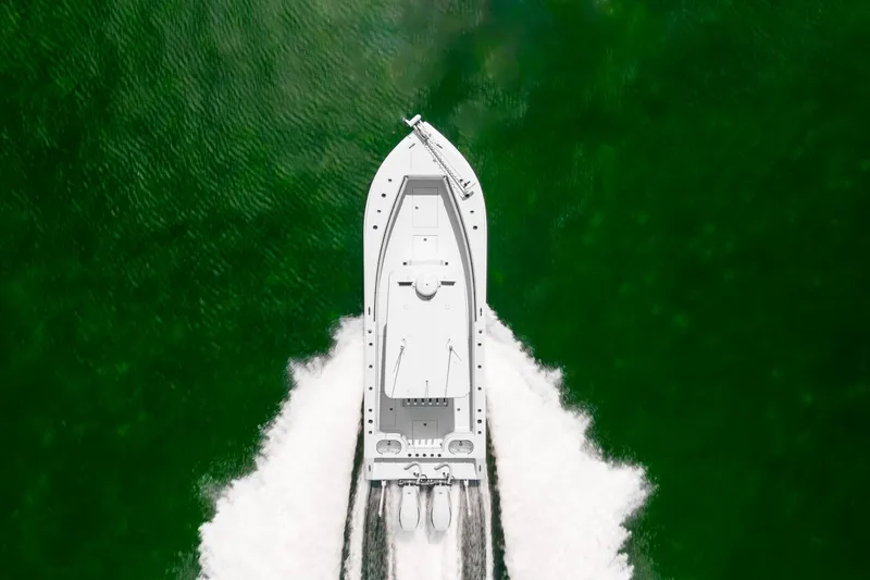 Slide: The Image of Aerial view of 2024 SeaHunter 28 Floridian boat cruising on green water. - 10