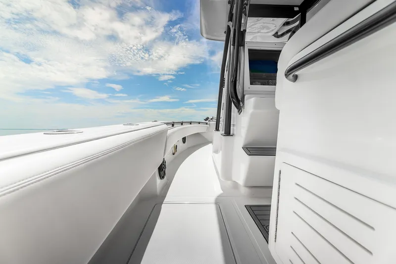 Slide: The Image of 2024 SeaHunter 28 Floridian boat interior with sleek white design and clear blue sky. - 12