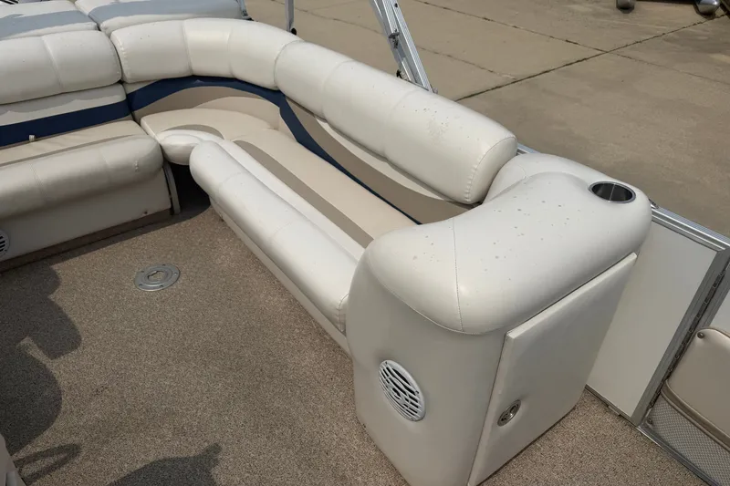 Slide: The Image of 2008 Crest 25 II XRS boat interior with white cushioned seating and cup holder. - 14